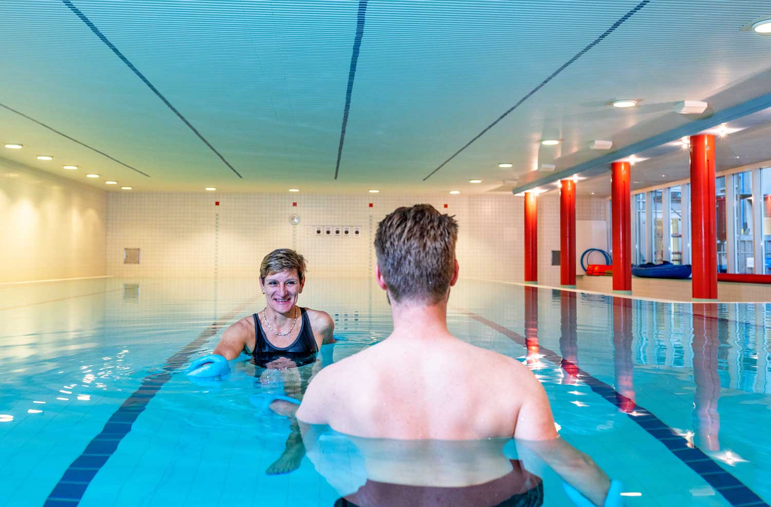 Two people move rhythmically in the therapy bath.