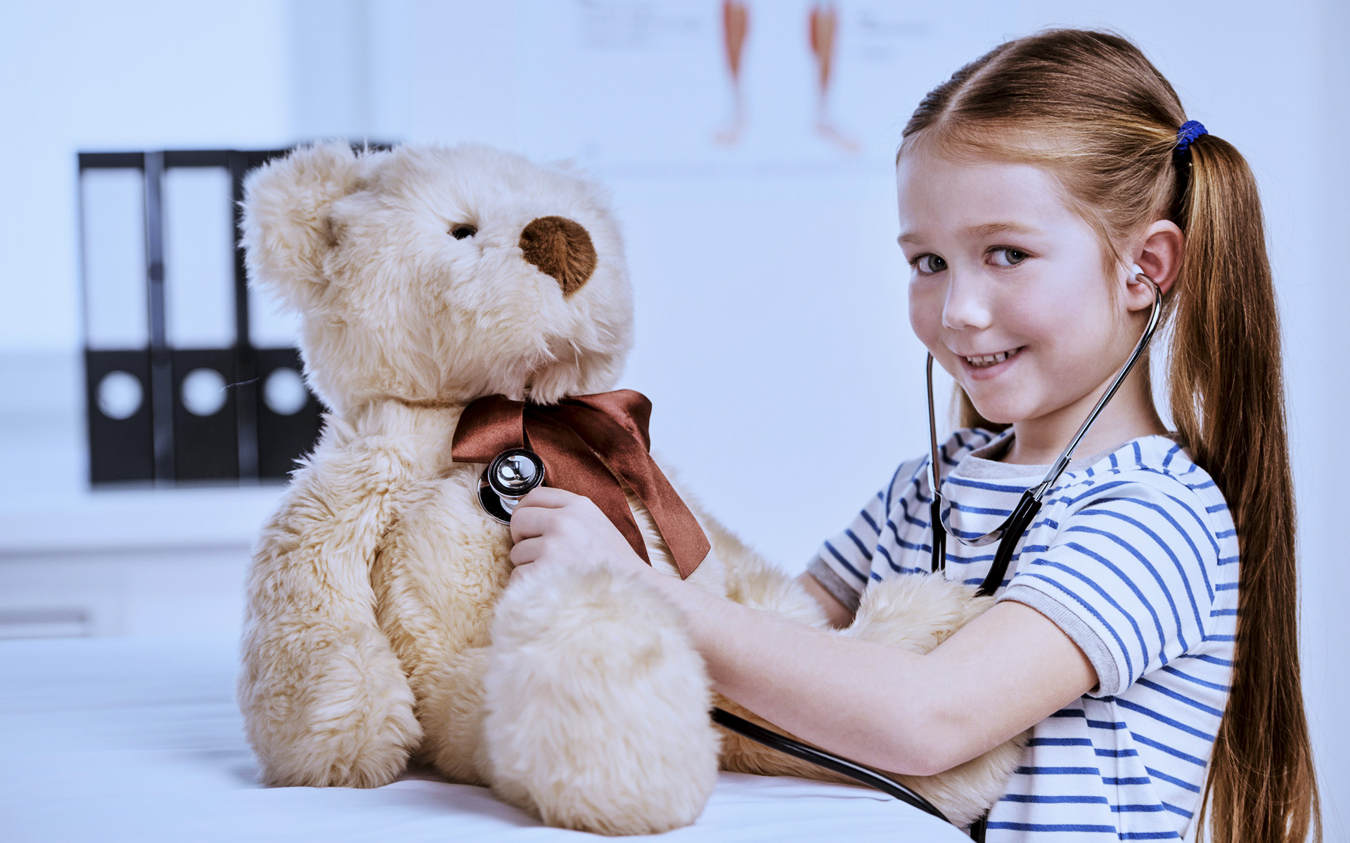 Little girl with a teddy bear in her hand.