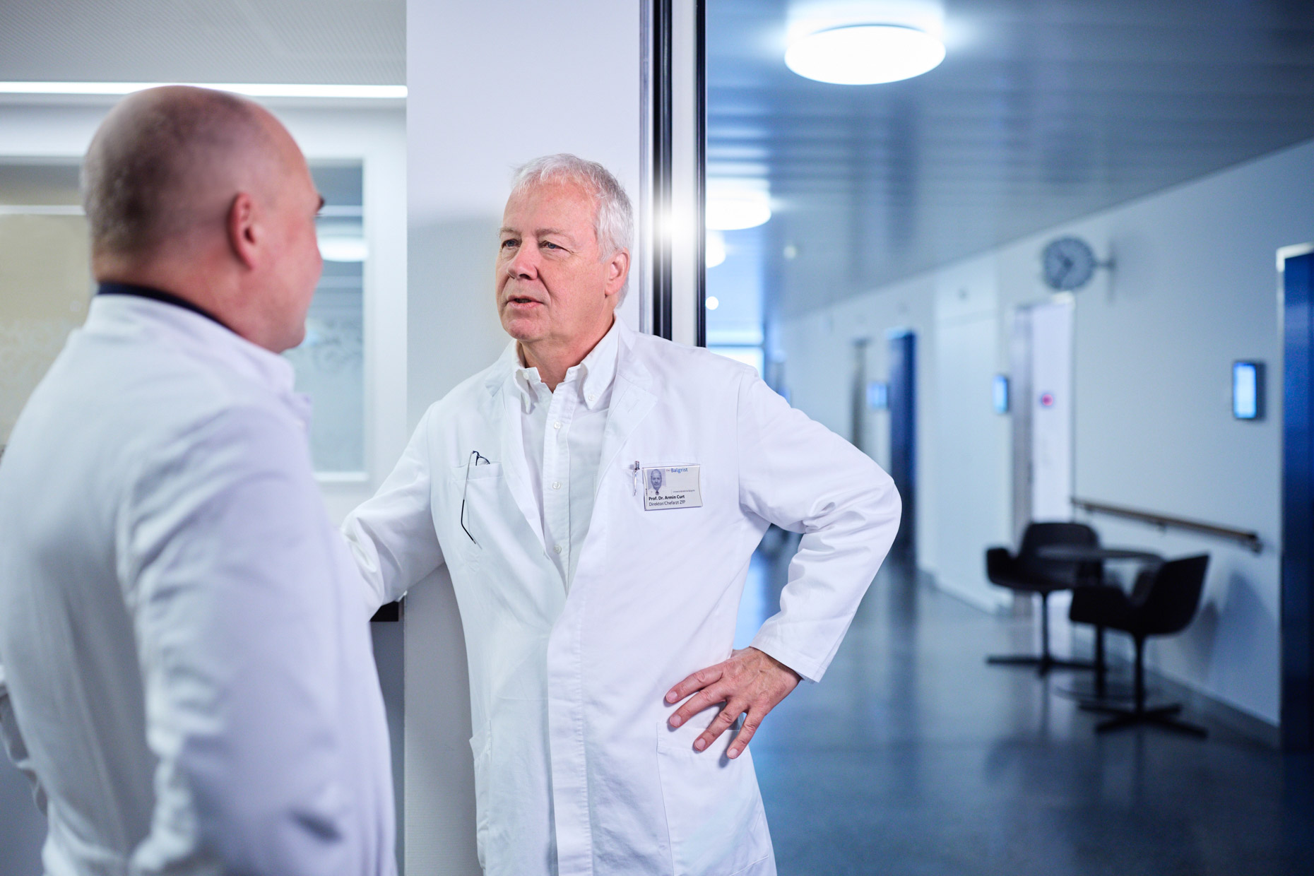 Discussion of two doctors in the hallway.